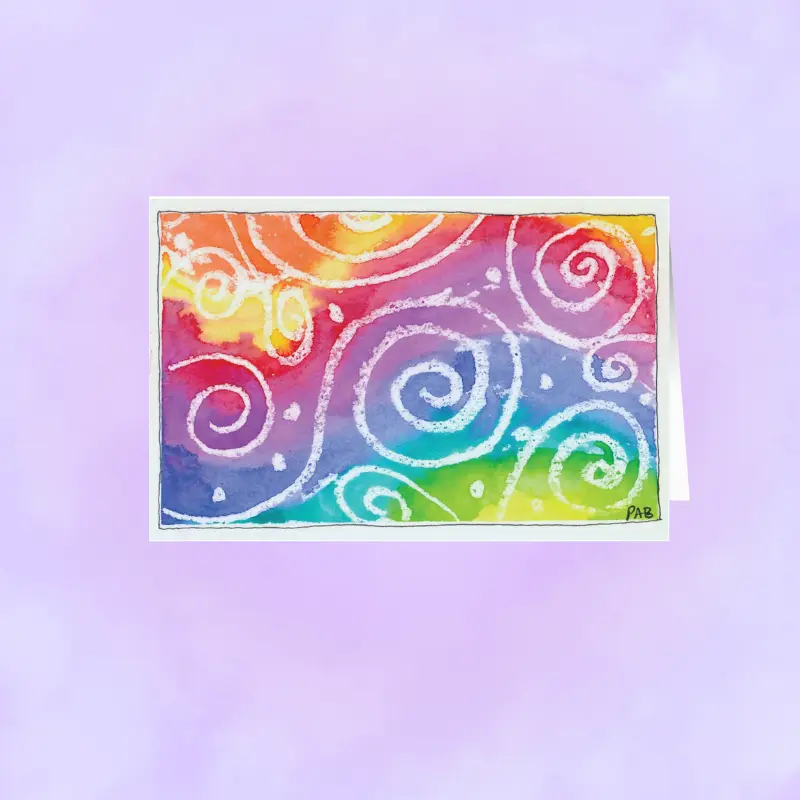 Close-up of a vibrant, hand-designed tie-dye artist print on matte premium stationery.
