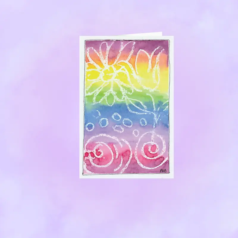 Close-up of a vibrant, hand-designed tie-dye artist print on matte premium stationery.