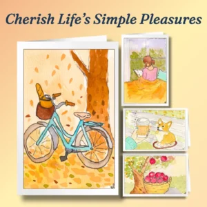 Life's Simple Pleasures card set features a bicycle with bread in the basket; a girl reading in a cozy window nook; a cup of coffee with a dog on a park bench; and a basket of freshly harvested apples.